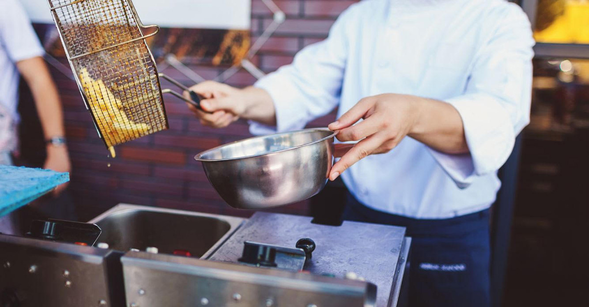 Chips cooking  in deep fat fryer