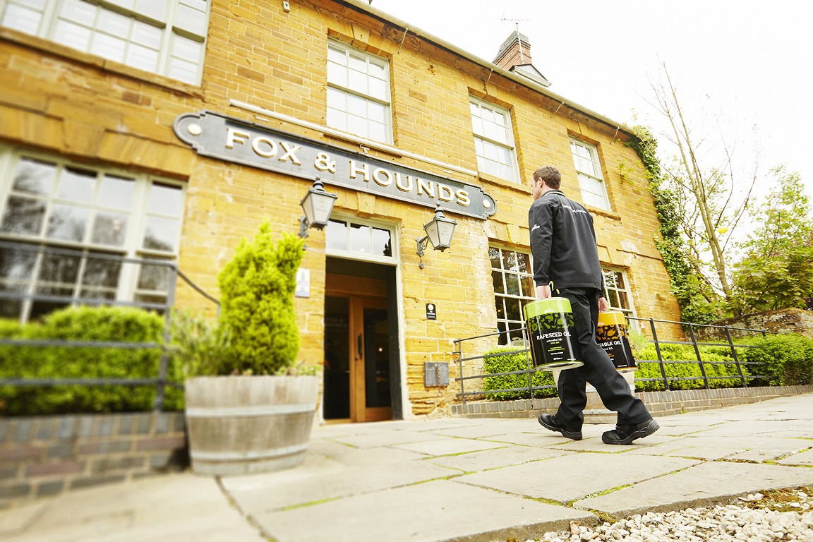 Olleco oil service driver delivering cooking oil to a pub